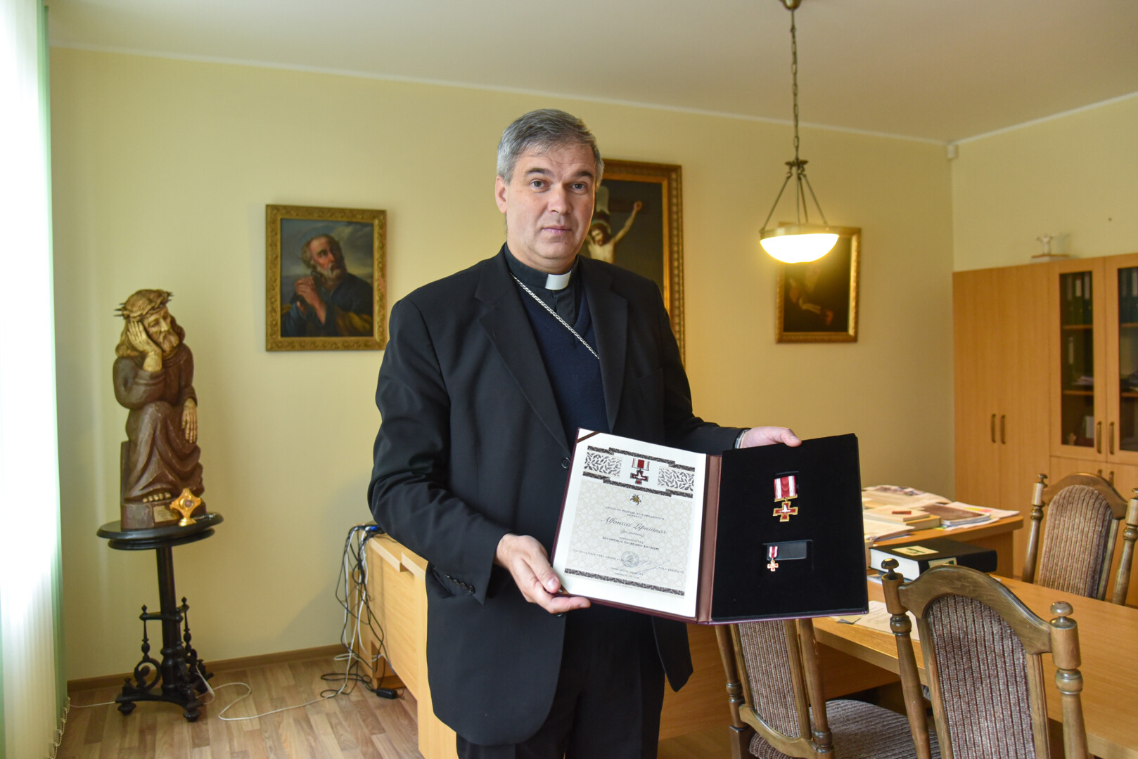 Vyskupo Lino Vodopjanovo (nuotraukoje – su Lietuvos prezidento kunigui Alfonsui Lipniūnui 2022-aisiais po mirties skirtu apdovanojimu – Žūvančiųjų gelbėjimo kryžiumi) svajonė – Panevėžio centre turėti A. Lipniūno muziejų. P. ŽIDONIO nuotr. 