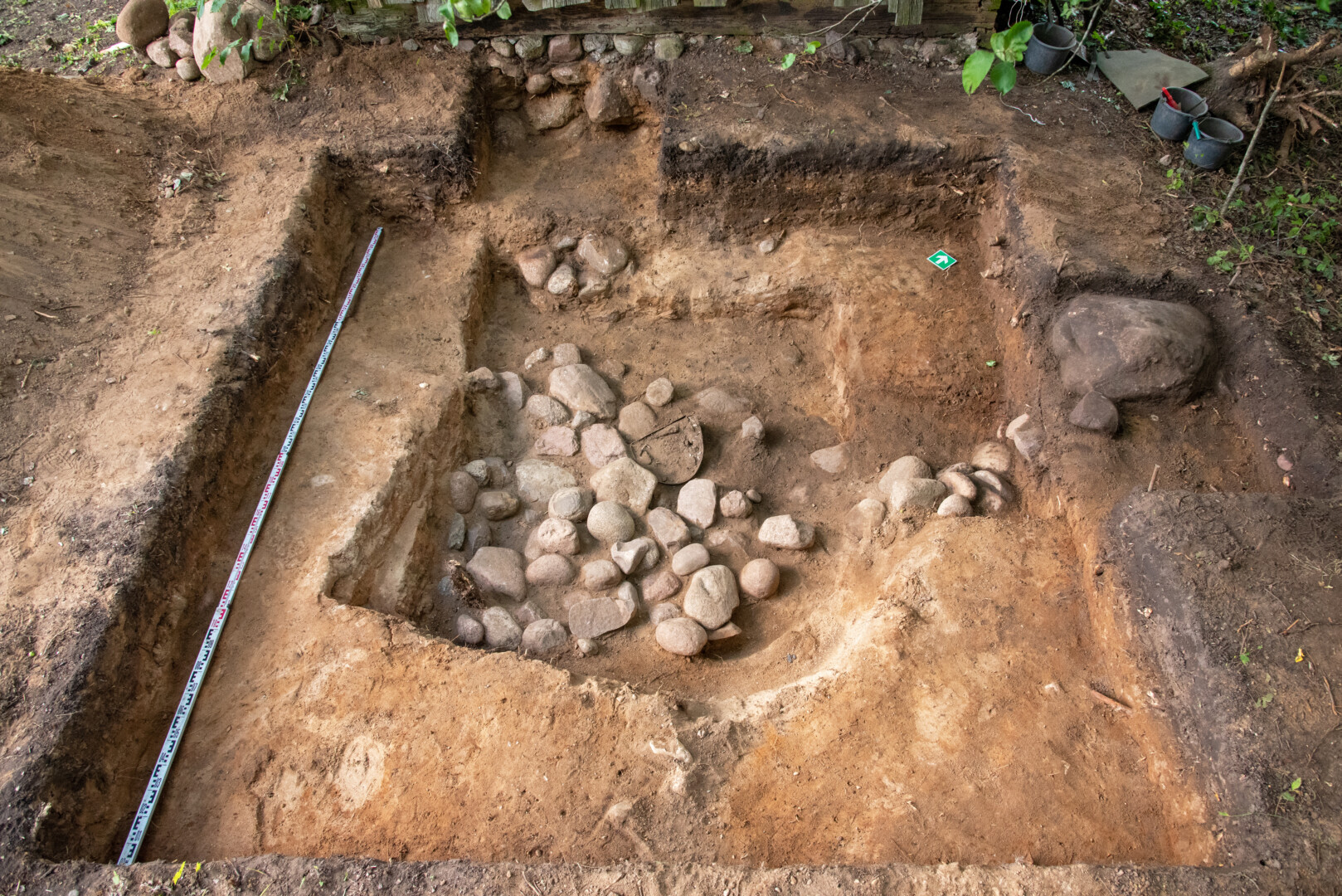 Kuršų kaimo bunkerio Telšių rajone tyrėjai prieš tai turėjo pašalinti ant jo užverstus akmenis. G. PETRAUSKO nuotr.